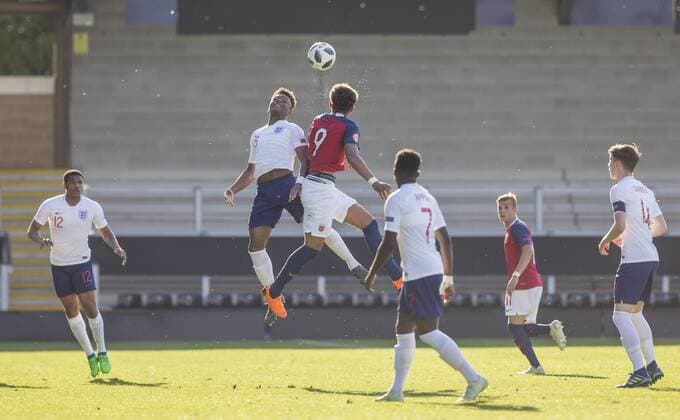 13th May 2018, Pirelli Stadium, Burton-upon-Trent, England; UEFA Under 17 European Championships, quarter final, Norway U17s versus England U17s; Ethan Laird of England and Noah Jean Holm of Norway clash in the air to head the ball  ActionPlus12024747