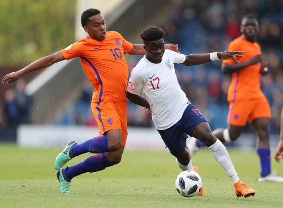 Quinten Maduro of the Netherlands tackles Bukayo Saka of England during the Semi Final match at the Proact Stadium, Chesterfield. Picture date 17th May 2018. Picture credit should read: Simon Bellis Sportimage EDITORIAL USE ONLY. No use with unauthorised audio, video, data, fixture lists, club league logos or live services. Online in-match use limited to 120 images, no video emulation. No use in betting, games or single club league player publications.