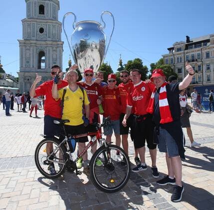 Real Madrid v Liverpool UEFA Champions League Final Liverpool fans and local fan wearing a Ukraine national team Nationalteam shirt in front of a giant Champions League Trophy before the UEFA Champions League Final at the Olympic Stadium, Kiev Content Not Available For UK Newspapers Copyright: xPaulxChestertonx FIL-11844-0027