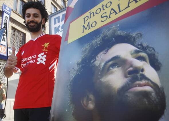 May 26, 2018 - Kiev, Ukraine - A man dressed like Liverpool s Mohamad Salah poses for a photo in front of the NSC Olimpiyskiy stadium in Kiev, Ukraine, 26 May 2018. Real Madrid will face Liverpool FC in the UEFA Champions League final at the NSC Olimpiyskiy stadium on 26 May 2018. Real Madrid vs Liverpool FC, UEFA Champions League final - ZUMAg194 20180526_zap_g194_014 Copyright: xSergxGlovnyx