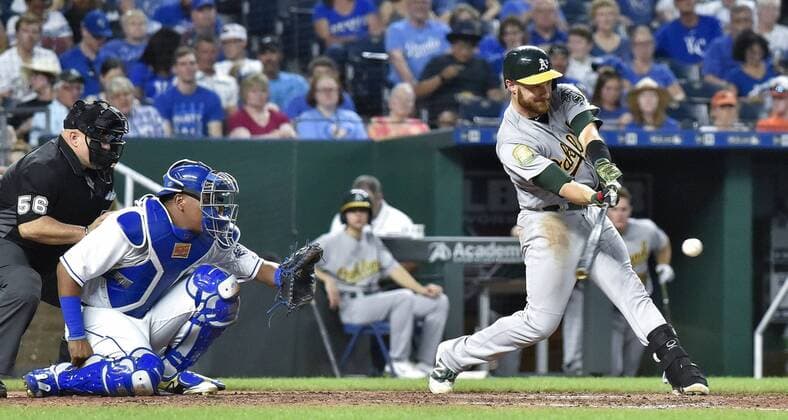 June 1, 2018 - Kansas City, MO, USA - The Oakland Athletics Jonathan Lucroy connects on a single in front of Kansas City Royals catcher Salvador Perez in the sixth inning on Friday, June 1, 2018, at Kauffman Stadium in Kansas City, Mo. The A s won, 16-0. Oakland at Kansas City - ZUMAm67_ 20180601_zaf_m67_023 Copyright: xJohnxSleezerx