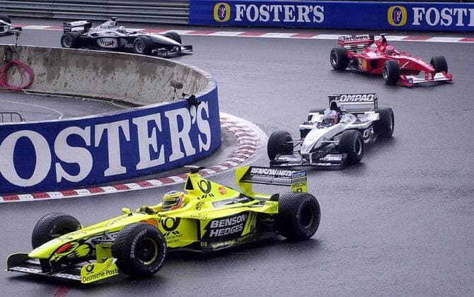 BRU43--SPA FRANCORCHAMPS, BELGIUM: (FORMULA ONE GRAND PRIX, BELGIUM) Italian Jordan Muger Honda driver Jarno Trulli (yellow) followed by British Williams-BMW driver Jenson Button after the first lap on the Spa-Francorchamps racetrack, 27 August 20000, during the Belgian Formula One Grand Prix. - OLIVIERxHOSLET  x503194x