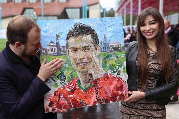 WM 2018, Ronaldo PortrÃ¤t aus Zeitungsausschnitten MOSCOW REGION, RUSSIA - JUNE 10, 2018: Artist Andrei Shatilov (L) shows a portrait of Portuguese football player Cristiano Ronaldo that he made using newspaper clippings, at Saturn Stadium in Kratovo, Moscow Region, where Portugal s national football team are having a training session ahead of the FIFA World Cup WM Weltmeisterschaft Fussball Russia 2018. Sergei Savostyanov TASS  TS083533