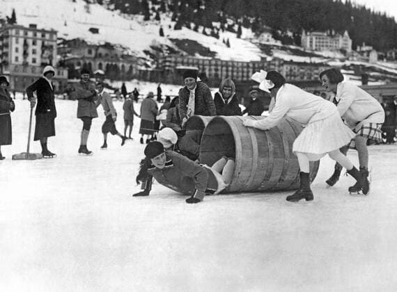 Davos, Switzerland: c. 1928. Young girls crawling through barrels as part of an ice skating obstacle race in Switzerland. xUnderwoodxArchives 3-Sport-IS-P_3 990_16_3-Sport-IS-P_3HR