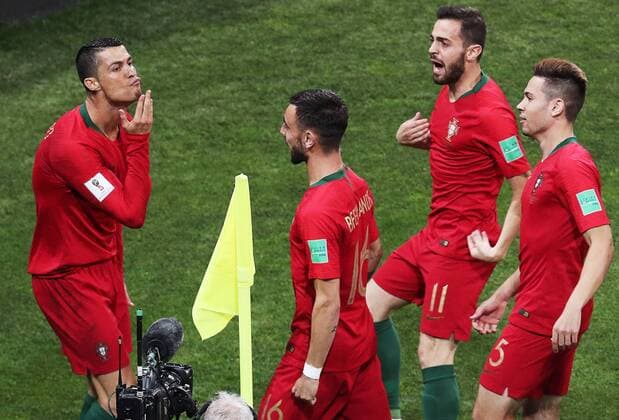 WM 2018, Portugal - Spanien SOCHI, RUSSIA â€“ JUNE 15, 2018: Portugal s Cristiano Ronaldo, Bruno Fernandes, Bernardo Silva, and Raphael Guerreiro (L-R) celebrate scoring in their 2018 FIFA World Cup WM Weltmeisterschaft Fussball Group B football match against Spain at Fisht Stadium. Mikhail Tereshchenko TASS  TS0846C9