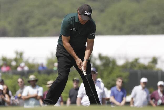 Phil Mickelson hits a putt on a ball that was still rolling on the 13th green in the third round at the 118th U.S. Open Championship at Shinnecock Hills Golf Club in Southampton, New York on June 16, 2018. Mickelson took a two-shot penalty, and he eventually made 10 on the hole. The hole moved Mickelson to 10 over for the day and 16 over for the tournament. He finished 17 over, but the USGA didn t disqualify him for a rules violation.  NYP20180616110 JOHNxANGELILLO