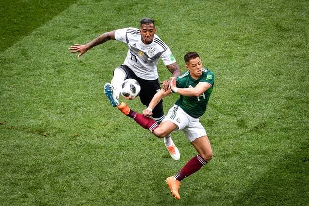 Jerome Boateng of Germany, left, challenges Javier Hernandez of Mexico in their Group F match during the FIFA World Cup WM Weltmeisterschaft Fussball 2018 in Moscow, Russia, 17 June 2018. Mexico takes lead in first half against Germany  20180617_90201