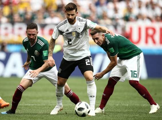MOSCOW, RUSSIA - JUNE 17, 2018: Mexico s Miguel Layun, Germany s Marvin Plattenhardt, and Mexico s Hector Herrera (L-R) fight for the ball in their 2018 FIFA World Cup WM Weltmeisterschaft Fussball Group F football match at Luzhniki Stadium. Valery Sharifulin TASS  TS084C64