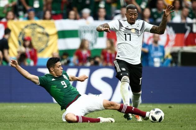 MOSCOW, RUSSIA - JUNE 17, 2018: Mexico s Raul Jimenez (L) and Germany s Jerome Boateng fight for the ball in their 2018 FIFA World Cup WM Weltmeisterschaft Fussball Group F football match at Luzhniki Stadium. Mexico won the game 1-0. Valery Sharifulin TASS  TS084C98