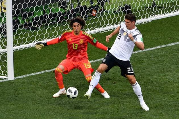 Guillermo Ochoa of Mexico, left, heads the ball against Mario Gomez of Germany in their Group F match during the 2018 FIFA World Cup WM Weltmeisterschaft Fussball in Moscow, Russia, 17 June 2018. Mexico won its World Cup opener, hanging on to defeat defending champion Germany 1-0 in Moscow. many  20180618_65615
