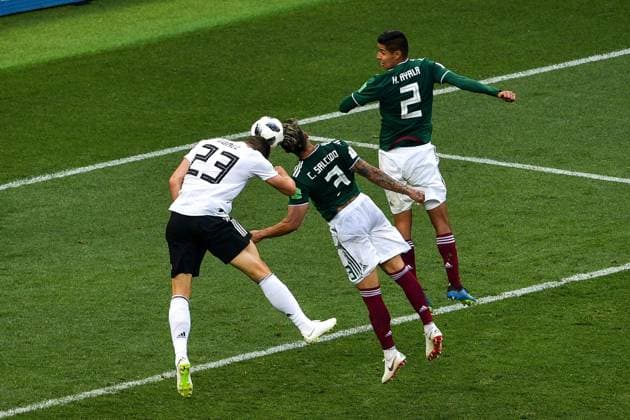 Carlos Salcedo of Mexico, center, heads the ball against Mario Gomez of Germany in their Group F match during the 2018 FIFA World Cup WM Weltmeisterschaft Fussball in Moscow, Russia, 17 June 2018. Mexico won its World Cup opener, hanging on to defeat defending champion Germany 1-0 in Moscow. many  20180618_65620