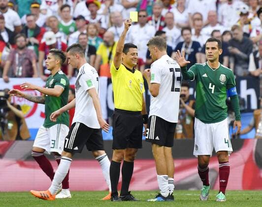 Football: Germany vs Mexico at World Cup Thomas Mueller of Germany (2nd from R) gets a yellow card during the second half of a 1-0 loss against Mexico in a World Cup group stage match at the Luzhniki Stadium in Moscow, Russia, on June, 17, 2018. 