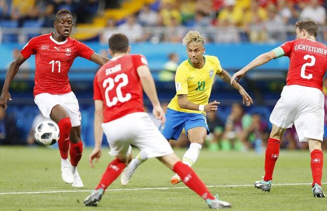 Football: Brazil vs Switzerland at World Cup Neymar (C) of Brazil slips the ball past Fabian Schaer (22), Stephan Lichtsteiner (2) and Denis Zakaria (11) of Switzerland during the second half of a World Cup group stage match in the southern Russian city of Rostov-on-Don on June 17, 2018. Brazil and Switzerland drew 1-1. 