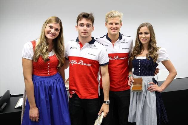 FORMULA 1 - GP of Austria 2018 SPIELBERG,AUSTRIA,29.JUN.18 - MOTORSPORTS, FORMULA 1 - Grand Prix of Austria, Red Bull Ring, free practice. Image shows Charles Leclerc (MON Sauber) and Marcus Ericsson (SWE Sauber) with girls. GEPAxpictures xChristianxWalgram