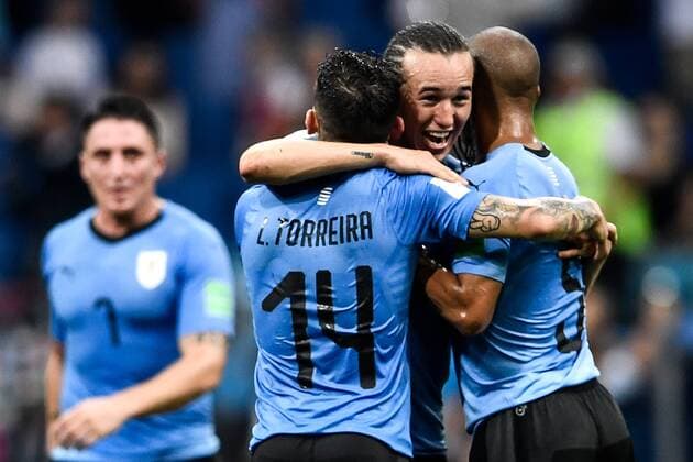 Players of Uruguay celebrate after the round of 16 match between Uruguay and Portugal during the 2018 FIFA World Cup WM Weltmeisterschaft Fussball in Sochi, Russia, 30 June 2018. Uruguay conceded their first Russia World Cup goal in the last 16 clash against Portugal but Edinson Cavani s double sent them through to the quarterfinals here on Saturday at the Fisht Olympic Stadium. They will next face France, who had earlier knocked out Lionel Messi s Argentina 4-3. Forward of Paris Saint-Germain, Cavani scored once at each half of the match, before he was injured and left the pitch supported by Portugal captain Cristiano Ronaldo. Portugal, after their impressive performances in four matches, will go home, and Real Madrid forward Ronaldo s fourth World Cup journey finished earlier than expected. Great efforts were mounted by the European Champions, who, in the 55th minute, for the first time at this World Cup struck a ball into the tightly-guarded Uruguay net. Cavani scores twice to send Uruguay to the last eight  20180701_02362