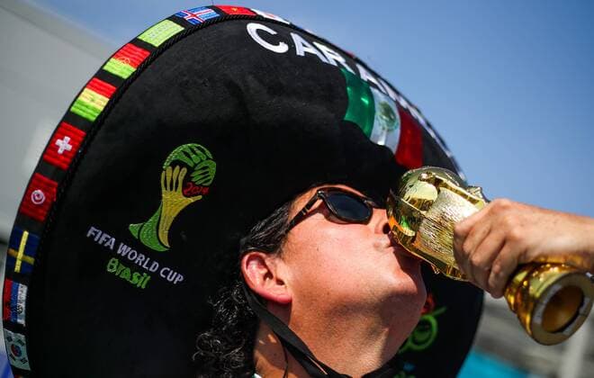 SAMARA, RUSSIA - JULY 2, 2018: A supporter of Mexico in a sombrero hat with a replica of the FIFA World Cup WM Weltmeisterschaft Fussball Trophy ahead of the Round of 16 football match between Brazil and Mexico at FIFA World Cup Russia 2018. Sergei Bobylev TASS  TS0878D9