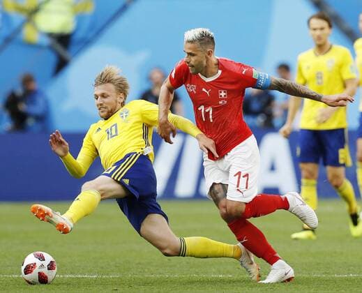 Football: Sweden vs Switzerland at World Cup Emil Forsberg (L) of Sweden and Valon Behrami of Switzerland battle for the ball during the first half of a World Cup round-of-16 match at Saint Petersburg Stadium in St. Petersburg, Russia, on July 3, 2018. 