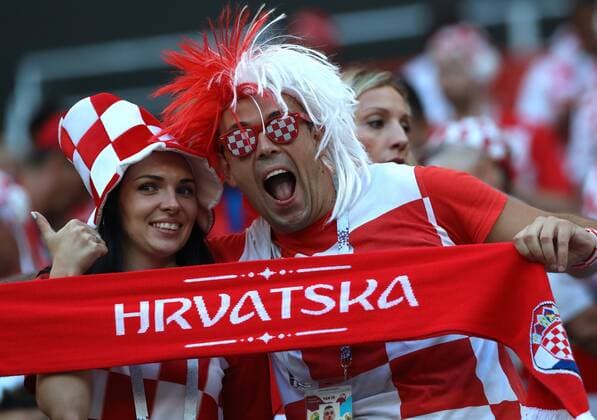 MOSCOW, RUSSIA - JULY 11, 2018: A Croatian football fan blows a trumpet in her team s 2018 FIFA World Cup WM Weltmeisterschaft Fussball semi-final match against England at Luzhniki Stadium. 