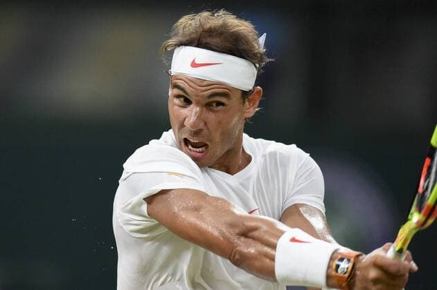 (180714) -- LONDON, July 14, 2018 -- Rafael Nadal of Spain hits a return during the men s singles semifinal match against Novak Djokovic of Serbia at the Wimbledon Championships 2018 in London, Britain, on July 13, 2018. The match was suspended due to the time issue. ) (SP)BRITAIN-LONDON-TENNIS-WIMBLEDON CHAMPIONSHIPS 2018-DAY 11 StephenxChung 