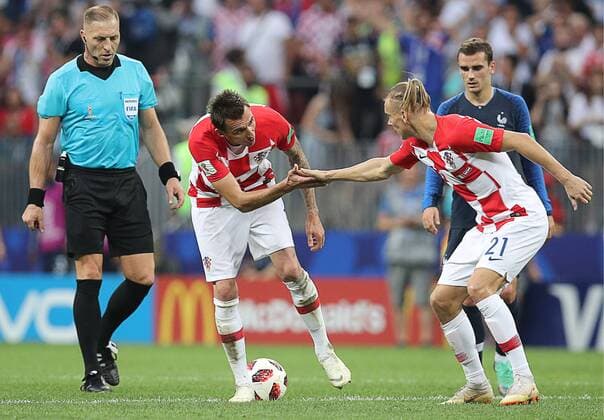 MOSCOW, RUSSIA â€“ JULY 15, 2018: Referee Nestor Pitana and Croatia s Mario Mandzukic, Domagoj Vida (L-R) in the 2018 FIFA World Cup WM Weltmeisterschaft Fussball final football match between France and Croatia at Luzhniki Stadium. Team France won the game 4:2 and claimed the World Cup title. Sergei Bobylev TASS  TS08999A
