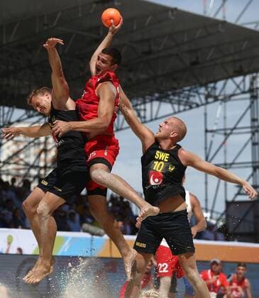 KAZAN, RUSSIA - JULY 24, 2018: Sweden s Erik Nilsson, Russia s Konstantin Vinokur, and Sweden s Henrik Dahlberg (L-R) in action in their beach handball match at the 2018 IHF Menâ€™s and Womenâ€™s Beach Handball World Championships held in Kazan. Yegor Aleyev TASS  TS08A8B3