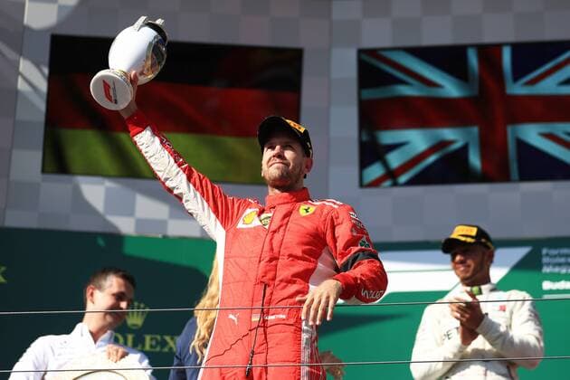 29th July 2018, Hungaroring, Mogyorod, Hungary; Hungarian Formula One Grand Prix, race day; Scuderia Ferrari, Sebastian Vettel comes home in second place and accepts his trophy on podium  ActionPlus12051638 Octane