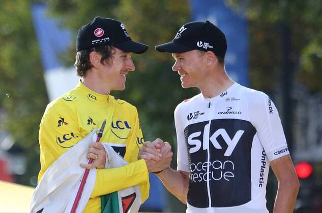 Geraint Thomas (L) and teammate Chris Froome of Great Britain celebrate on the presentation podium after Thomas won the Tour de France in Paris on July 29, 2018. Thomas claimed his first Tour de France victory, becoming the first Welshman to win the event.  PAR20180729011 DAVIDxSILPA