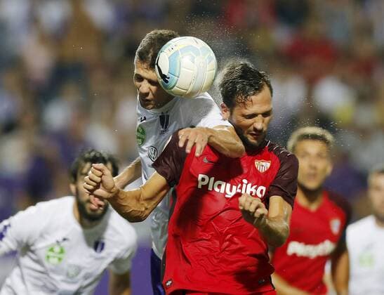BUDAPEST, HUNGARY - AUGUST 2: (l-r) Benjamin Balazs of Ujpest FC battles for the ball in the air with Franco Vazquez of Sevilla FC during the UEFA Europa League Second Qualifying Round 2nd Leg match between Ujpest FC and Sevilla FC at Ferenc Szusza Stadium on August 2, 2018 in Budapest, Hungary. LaszloxSzirtesi 