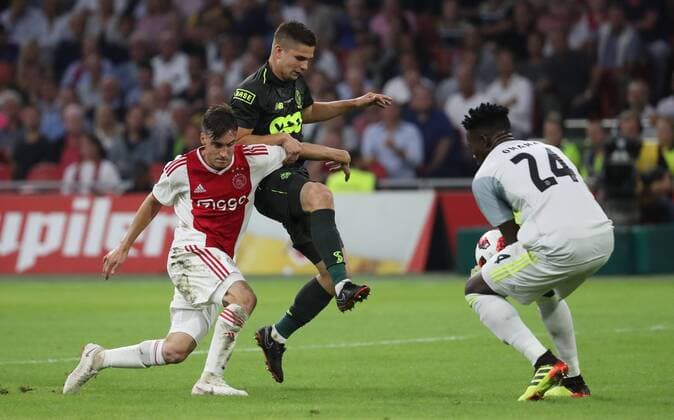 Ajax Nicolas Tagliafico and Standard s Razvan Marin fight for the ball during a soccer game between Dutch club AFC Ajax and Belgian team Standard de Liege, Tuesday 14 August 2018 in Amsterdam, the Netherlands, the return leg of the third qualifying round of the UEFA Champions League. The first leg resulted in a 2-2 draw. VIRGINIExLEFOUR  x05405892x