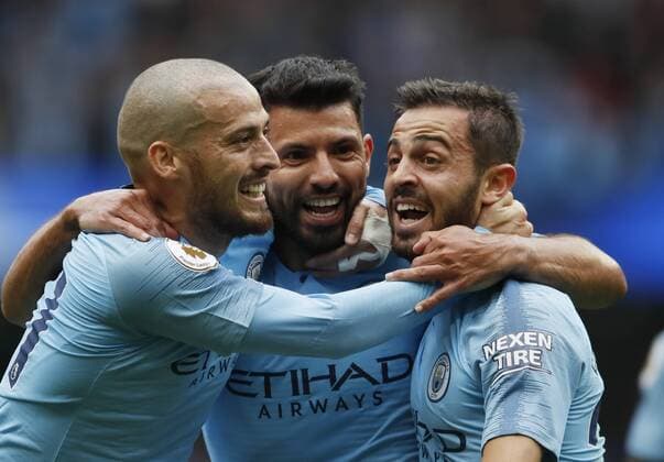 Sergio Aguero of Manchester City (c) celebrates scorn the first with David Silva of Manchester City and Bernardo Silva of Manchester City during the Premier League match at the Etihad Stadium, Manchester. Picture date 19th August 2018. Picture credit should read: Simon Bellis Sportimage EDITORIAL USE ONLY. No use with unauthorised audio, video, data, fixture lists, club league logos or live services. Online in-match use limited to 120 images, no video emulation. No use in betting, games or single club league player publications.