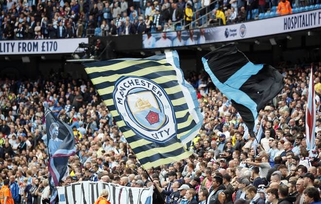Manchester City fans with flags during the Premier League match at the Etihad Stadium, Manchester. Picture date 19th August 2018. Picture credit should read: Simon Bellis Sportimage EDITORIAL USE ONLY. No use with unauthorised audio, video, data, fixture lists, club league logos or live services. Online in-match use limited to 120 images, no video emulation. No use in betting, games or single club league player publications.