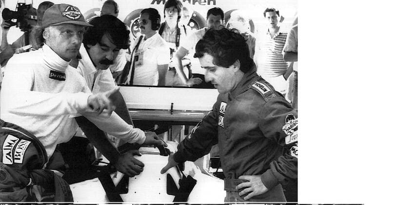 HOCKENHEIM ---- AUSTRIA S NIKI LAUDA, LEFT, AND FRENCH TEAM MATE ALAIN PROST, right, TALK STRATEGY AS THEY STAND AT A MCLAREN-PORSCHE MP 4 2 FORMULA I RACING CAR BEFORE FIRST OFFICIAL PRACTICE 03 08 FOR THE FORMULA-1 GRAND PRIX OF GERMANY AT HOCKENHEIMRING. PROST LEADS THE World Championship WM Weltmeisterschaft WITH 34.5 POINTS, MCLAREN TEAM MATE LAUDA IS RUNNER-UP HOLDING 33 POINTS. .JEP WST BELGA.  x85105198stx