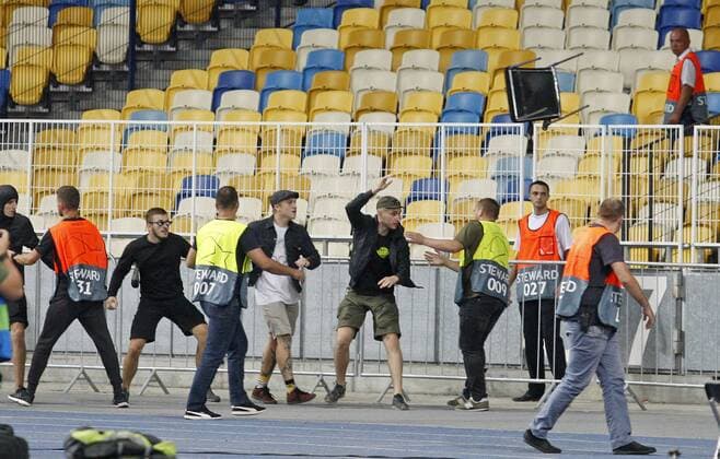 August 28, 2018 - Kiev, Ukraine - Stewards try to stop local soccer hooligans from throwing a chair at Ajax fans before the UEFA Champions League play-off, second leg, soccer match between FC Dynamo Kyiv and Ajax Amsterdam, at the Olimpiyskiy stadium in Kiev, Ukraine, on 28 August 2018. Ajax Amsterdam vs FC Dynamo Kiev , UEFA Champions League soccer match - ZUMAg194 20180828_zap_g194_027 Copyright: xSergxGlovnyx