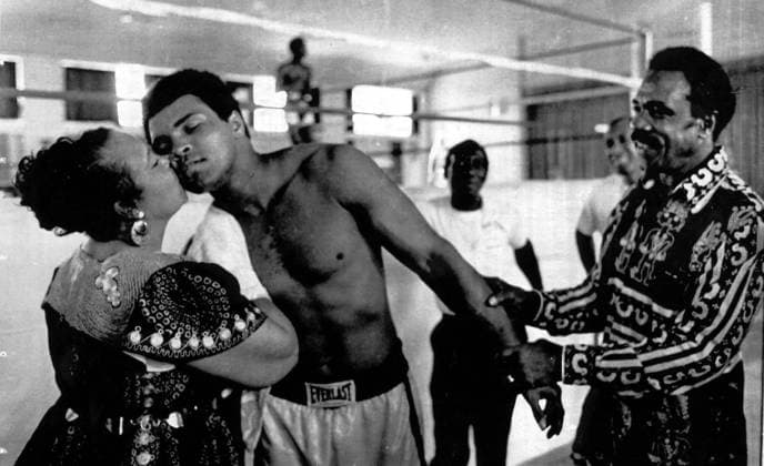 HEAVYWEIGHT CHALLENGER, MUHAMMAD ALI GETS A MOTHERLY KISS FROM HIS MOTHER, ODESSA CLAY AND A WARM TOUCH FROM HIS FATHER, CASSIUS AT HIS TRAINING CAMP ION N SELE, ZAIRE.. .JVB WST BELGA  x85196588stx