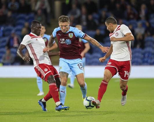 30th August 2018, Turf Moor, Burnley, England; Europa League football playoff 2nd leg, Burnley versus Olympiakos; Jeff Hendrick of Burnley trees to get past the tackles of Mady Camara and Omar Elabdellaoui of Olympiakos  ActionPlus12059274 ConorxMolloy