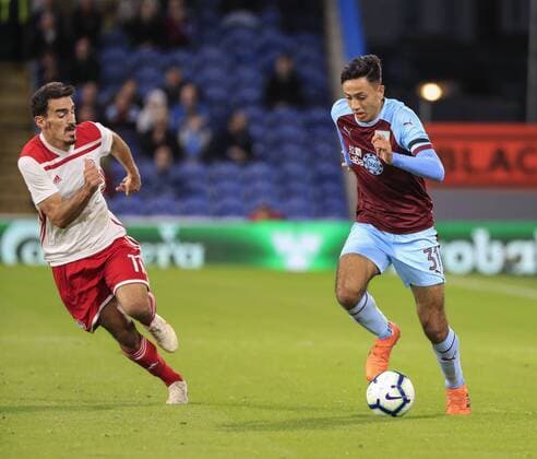 30th August 2018, Turf Moor, Burnley, England; Europa League football playoff 2nd leg, Burnley versus Olympiakos; Dwight McNeil of Burnley runs away from a challenge from Lazaros Christodoulopoulos of Olympiakos  ActionPlus12059329 ConorxMolloy