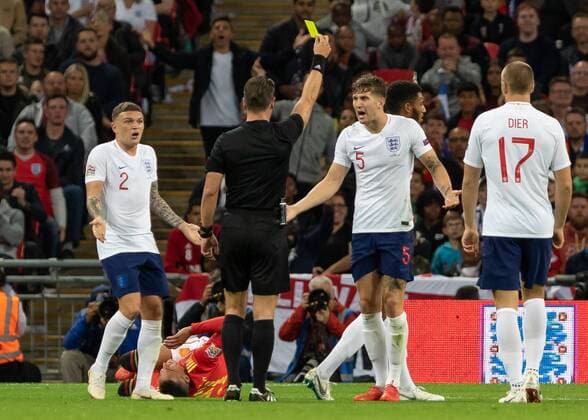Football - 2018 2019 UEFA Nations League A - Group Four: England vs. Spain John Stones (England) and Kieran Trippier (England) protest to the Referee Danny Makkelie (NED) as the England player receives a yellow card at Wembley Stadium. COLORSPORT DANIEL BEARHAM  csp_eng_spa_080918_