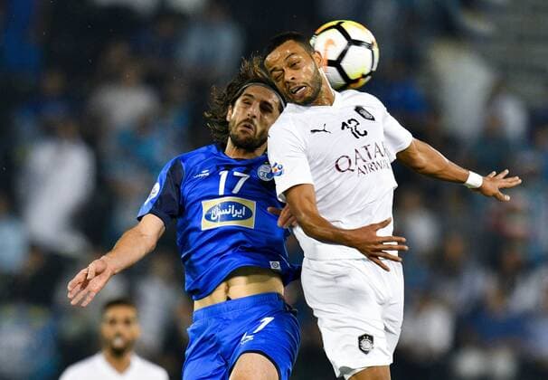 (180918) -- DOHA, Sept. 18, 2018 -- Hamid Ismaeil (R) of Al Sadd vies with Humam Tareq of Esteghlal FC during the AFC Asian Champions League quarterfinal second leg football match between Qatar s Al Sadd and Iran s Esteghlal FC in Doha, capital of Qatar, Sept. 17, 2018. Al Sadd was qualified for the semifinal after a 2-2 draw in the second leg of the quarterfinal with Esteghlal FC gave them a 5-3 aggregate win. ) (SP)QATAR-DOHA-FOOTBALL-AFC-ASIAN CHAMPIONS LEAGUE Nikku 