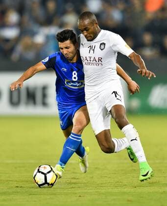 (180918) -- DOHA, Sept. 18, 2018 -- Abdelkarim Hassan (R) of Al Sadd vies with Farshid Esmaeili of Esteghlal FC during the AFC Asian Champions League quarterfinal second leg football match between Qatar s Al Sadd and Iran s Esteghlal FC in Doha, capital of Qatar, Sept. 17, 2018. Al Sadd was qualified for the semifinal after a 2-2 draw in the second leg of the quarterfinal with Esteghlal FC gave them a 5-3 aggregate win. ) (SP)QATAR-DOHA-FOOTBALL-AFC-ASIAN CHAMPIONS LEAGUE Nikku 