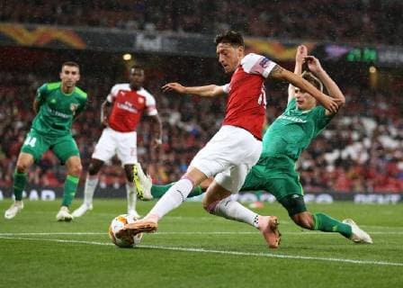 & xa7;20th September 2018, Emirates Stadium, London, England; UEFA Europa League football, Arsenal versus Vorskla Poltava; Mesut Ozil of Arsenal attempting to keep the ball in play as Oleksandr Sklyar of Vorskla Poltava slides in to block  ActionPlus12064075 JohnxPatrickxFletcher