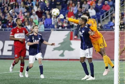 FOXBOROUGH, MA - SEPTEMBER 22: Chicago Fire goalkeeper Richard Sanchez (33) punches the ball away over New England Revolution forward Juan Agudelo (17) during a match between the New England Revolution and the Chicago Fire on September 22, 2018, at Gillette Stadium in Foxborough, Massachusetts. The teams played to a 2-2 draw. (Photo by Fred Kfoury III Icon Sportswire) SOCCER: SEP 22 MLS Fussball Herren USA - Chicago Fire at New England Revolution Icon482180922034 EDITORIAL USE ONLY