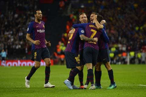 Coutinho celebrates after scoring his sides first goal whit Lionel Messi of Barcelona Group B match of the UEFA Champions League between Tottenham Hotspurs and FC Barcelona Barca at Wembley Stadium on October 03, 2018 in London, England.