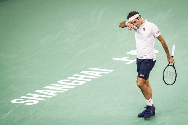 Roger Federer of Switzerland wipes off sweat as he competes against Borna Coric of Croatia in their men s singles semi-final match during the Rolex Shanghai Masters tennis tournament in Shanghai, China, 13 October 2018. Borna Coric defeated Roger Federer 2-0 (6 4, 6 4). Borna Coric edges out Roger Federer to advance into Shanghai Masters final  pbu883966_06