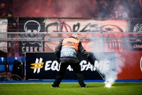 A steward tries to pick up a smoking object, during a match between Belgian soccer team KRC Genk and Turkish club Besiktas, in Genk, Thursday 08 November 2018 on day four of the UEFA Europa League group stage, in group I. JASPERxJACOBS  x05464326x