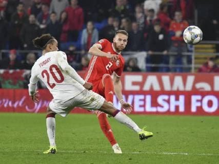 Football - 2018 2019 UEFA Nations League B - Group Four: Wales vs. Denmark Chris Gunter of Wales & Yussuf Poulsen of Denmark, at Cardiff City Stadium. COLORSPORT WINSTON BYNORTH 