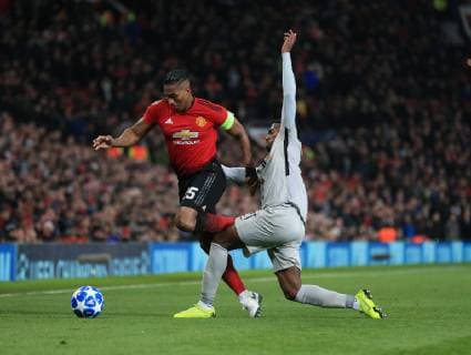 Antonio Valencia of Manchester United ManU tackled by Ulisses Garcia of Young Boys during the UEFA Champions League match at Old Trafford, Manchester. Picture date 27th November 2018. Picture credit should read: Matt McNulty Sportimage EDITORIAL USE ONLY. No use with unauthorised audio, video, data, fixture lists, club league logos or live services. Online in-match use limited to 120 images, no video emulation. No use in betting, games or single club league player publications.