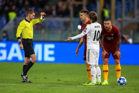 27th November 2018, Stadio Olimpico, Rome, Italy; UEFA Champions League football, AS Roma versus Real Madrid; referee Clement Turpin shows the yellow card to Luka Modric of Real Madrid  ActionPlus12083553 GiampieroxSposito