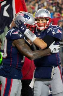 New England Patriots wide receiver Josh Gordon (10) gets a hug from quarterback Tom Brady after the two connected for a touchdown reception in the third quarter against the Minnesota Vikings at Gillette Stadium in Foxborough, Massachusetts on December 2, 2018. The Patriots defeated the Vikings 24-10.  BOS20181202116 MATTHEWxHEALEY