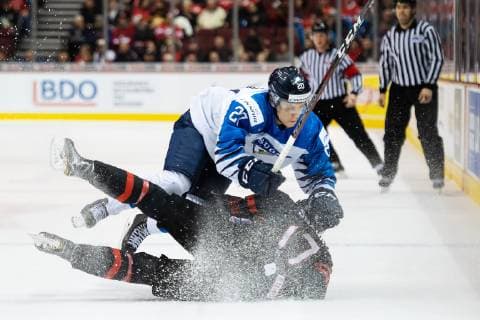 181223 Eeli Tolvanen of Finland tackles Nicholas Suzuki of Canada during the U20 Ice hockey Eishockey game between Finland and Canada on December 23, 2018 in Vancouver. Photo: Joel Marklund BILDBYRN kod JM 87821 Copyright: JOELxMARKLUND BB181223JM003