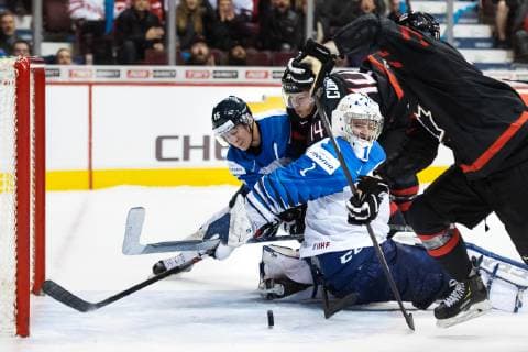 181223 Henri Jokiharju and goaltender Ukko-Pekka Luukkonen of Finland are being challenged by Maxime Comtois and Twin Tippett of Canada during the U20 Ice hockey Eishockey game between Finland and Canada on December 23, 2018 in Vancouver. Photo: Joel Marklund BILDBYRN kod JM 87821 Copyright: JOELxMARKLUND BB181223JM019